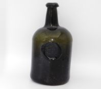 An 18thC. glass seal bottle, J. Braddon of Bridger