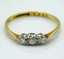 An 18ct gold ring set with three small diamonds of