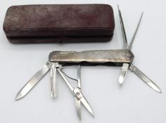 A 1932 Sheffield silver cased multi-tool with case