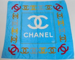 A ladies Chanel silk scarf bearing Chanel emblem,
