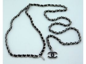 A 2002 Chanel silver tone & black leather chain be