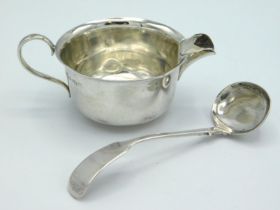 A 1923 Birmingham silver creamer of plain form by William Hutton & Sons twinned with an 1891 Victori