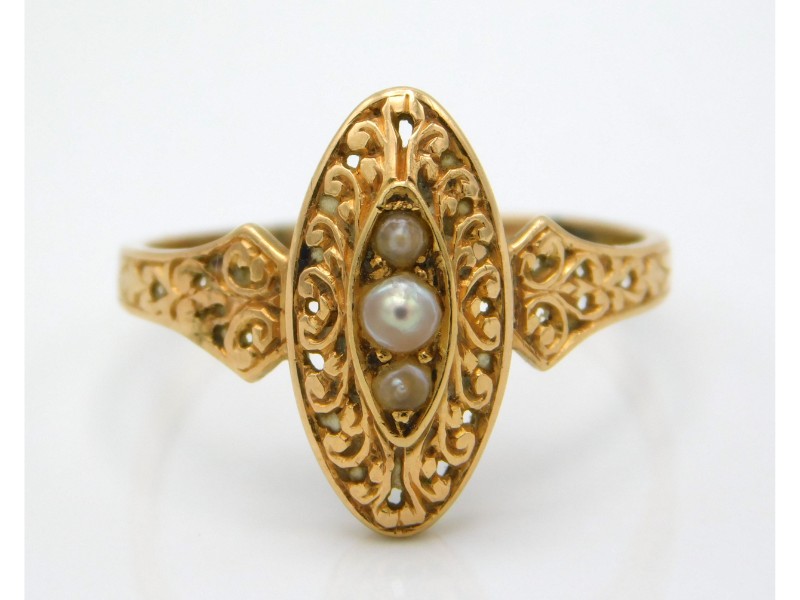 An antique yellow metal ring with carved decor, se