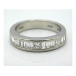A platinum half eternity ring set with princess cu