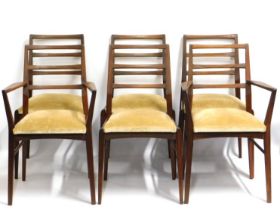 A Danish style teak dining suite comprising extending table, two carvers & four chairs, all of elega