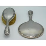 A 1919 Birmingham silver mounted mirror & brush by Martin Hall & Co. Ltd, mirror 280mm long