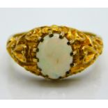 A carved 9ct gold ring set with opal, 4.1g, size N