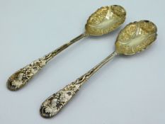A pair of ornate 19thC. white metal with gilded bowls berry spoons, decorated with grape & vine, 235