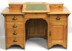 An early 20thC. light oak writing desk, 1359mm wide x 876mm high x 752mm deep