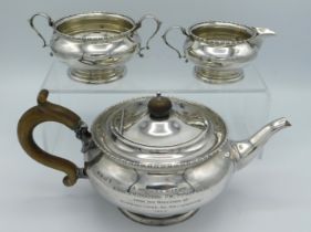 A 1923 Birmingham silver three piece tea set by William Noble with inscription 'Wedding Gift to Brot