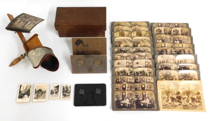 An antique stereoscope viewer with 22 Underwood & Underwood stereoscope cards twinned with two other
