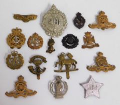 A selection of mostly military cap badges includin