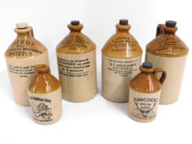 Four stoneware flagons including Bristol, Manchest