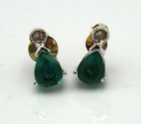 A pair of 9ct gold earrings set with emerald & sma