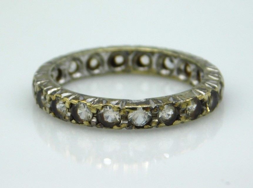 A 9ct gold eternity ring set with paste stones, 3g, size N/O