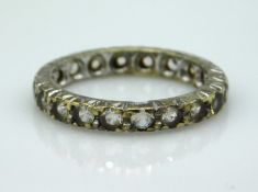 A 9ct gold eternity ring set with paste stones, 3g, size N/O