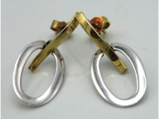 A pair of two colour metal earrings, test electron