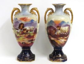 A pair of decorative c.1910 vases with cattle deco