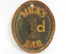 An oval wooden bar sign, 'Mick's 1d Bar', some fau