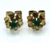 A pair of yellow metal earrings, test electronically as 9ct gold set with green stones, 1g