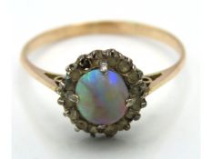 A 9ct gold ring set with opal & white stones, one