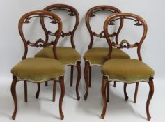 A set of four 19thC. Walnut balloon back dining ch