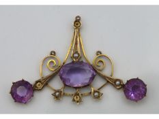 An antique 9ct gold pendant set with amethyst & pe