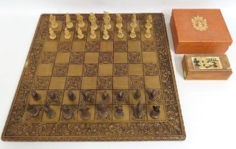 A large carved style chess board with pieces twinn