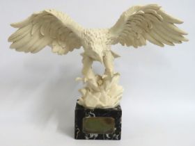 A granite mounted resin eagle with plaque "Awarded