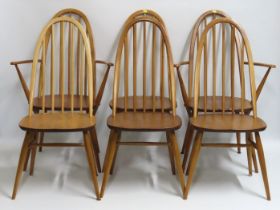 A set of six Ercol elm dining chairs including two