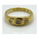 An 18ct gold ring set with three diamonds of appro