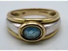 A 9ct two colour gold ring set with possibly zirco