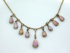 A gilt necklace mounted with opal style stones, 17
