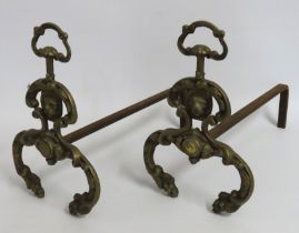 A pair of decorative antique brass fire dogs, 308m