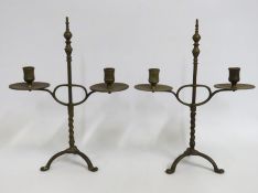A pair of brass rise & fall candle holders, each a