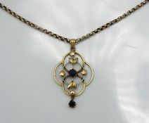 An early 20thC. chain & pendant, set with blue sto
