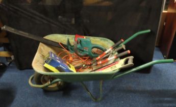 A garden wheelbarrow, an electric hedge trimmer, a