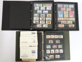 Three stamp albums including one mostly mint Briti