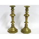 A pair of brass Victorian candle sticks with pushe