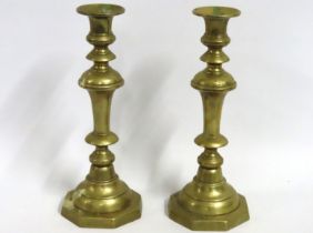 A pair of brass Victorian candle sticks with pushe