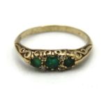 An antique 9ct gold ring set with emerald & four s