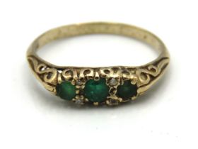 An antique 9ct gold ring set with emerald & four s