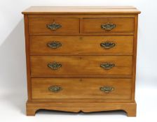 A satinwood chest of drawers, repairable split to