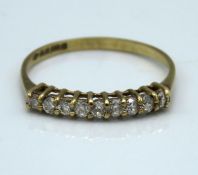 A 9ct half eternity ring set with nine small diamonds of approx. 0.27ct, 1g, size N