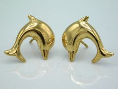 A pair of yellow metal, test as 9ct, dolphin earrings, lacking backs, 0.7g, 18mm wide