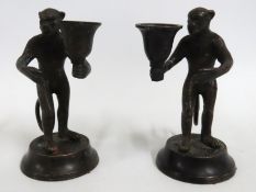A pair of bronze reproduction monkey candle holder