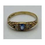 An antique 9ct gold ring with carved decor set wit