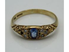 An antique 9ct gold ring with carved decor set wit