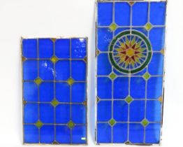 Two stained glass windows, one with radiant sun fe