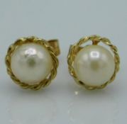 A pair of 9ct gold mounted pearl earrings, 0.8g, 7
